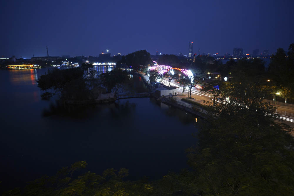 Đường Thanh Niên nằm giừa hồ Trúc Bạch và hồ Tây như dải lụa phát sáng về đêm.