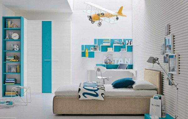 This breezy aqua and white color scheme, with yellow accessories, would suit either a boy or a girl. A corrugated feature wall adds texture to the predominantly white room, and a cluster of framed pictures makes things look homey. Stepped display shelves keep collections in check and looking stylish.