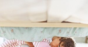 Girl looking under her bed