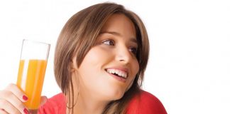 Pretty-young-woman-holding-a-glass-of-fruit-juice 1140