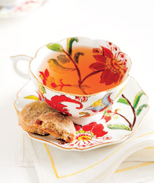 Flower tea cup with cookies on a white napkin