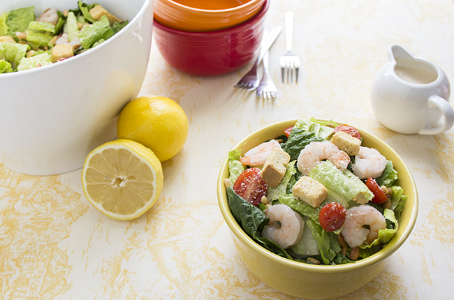 Shrimp Caesar Salad in bowl with extra salad