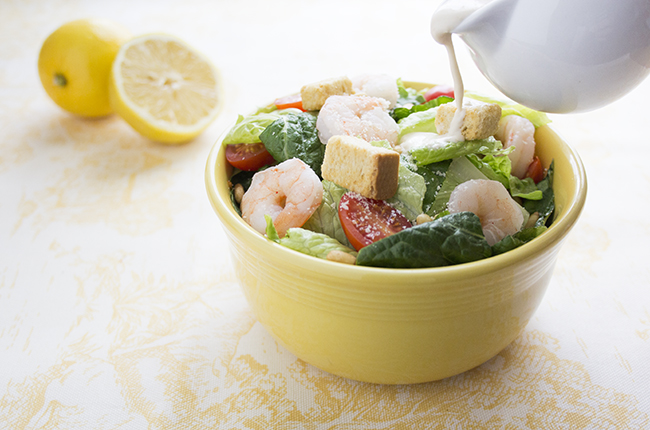 shrimp caesar salad with ingredients with dressing