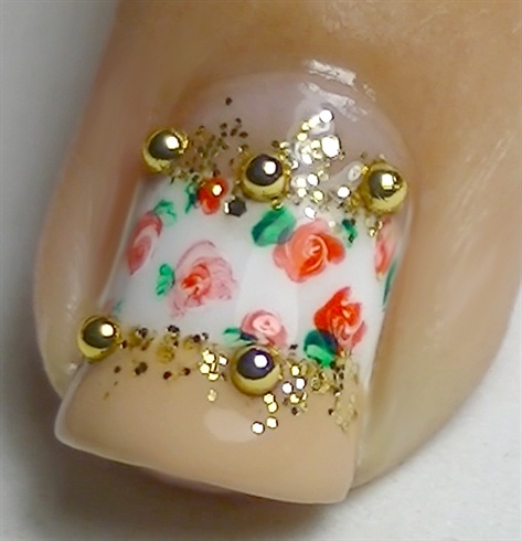 Add a layer of top coat and finish off by placing golden micro beads